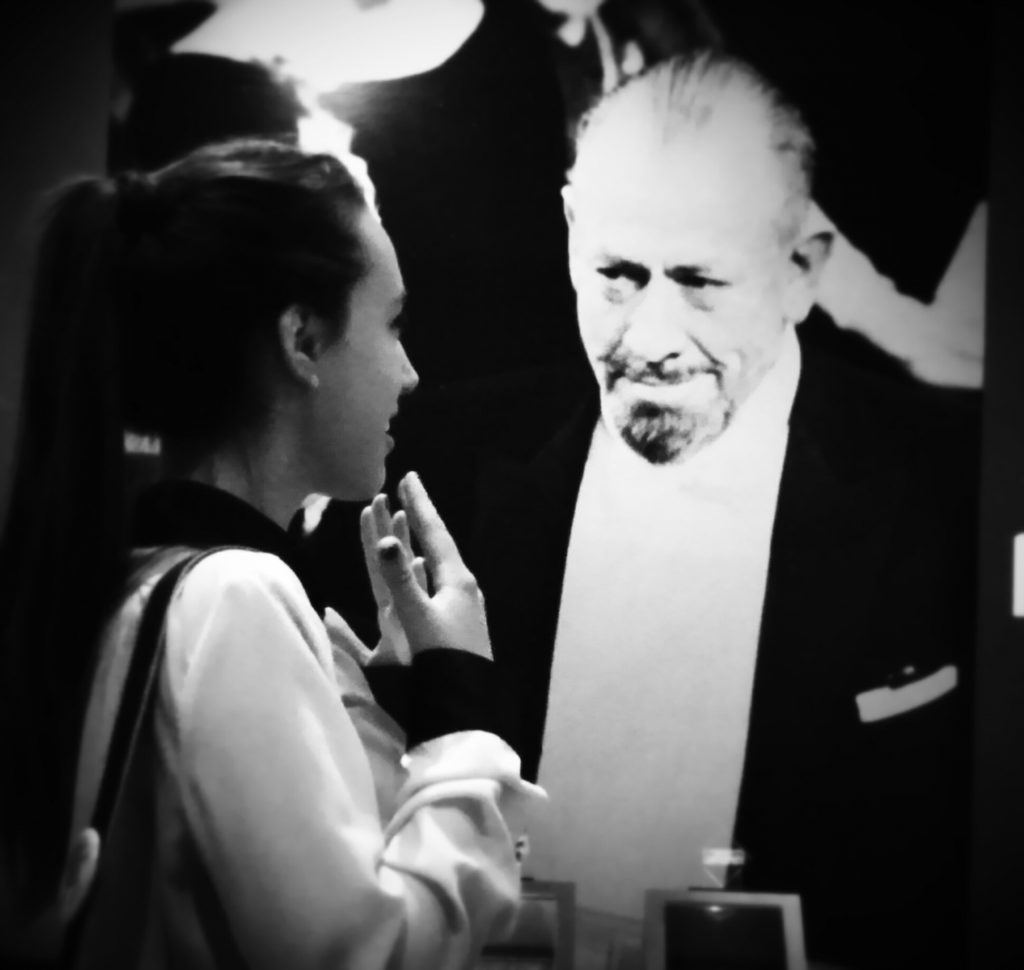 Wilcox's granddaughter poses with a picture of Steinbeck at the museum in Salinas.