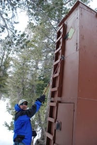 Snow Survey Director Dr. Mike Strobel indicates the upper door at a Snow Telemetry (SNOTEL) site. The upper door, which allows snow surveyors access when snowpack is deep, went unused this winter.