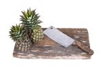 Chopping block and cleaver with pineapple-leftover food scraps