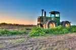 Tractor parked among weeds-farmland-Rabobank