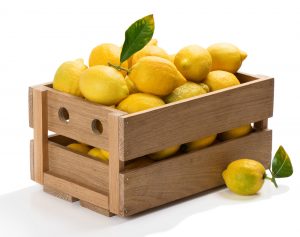 Wooden box full of fresh lemons