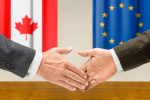 Representatives of Canada and the EU shake hands-trade
