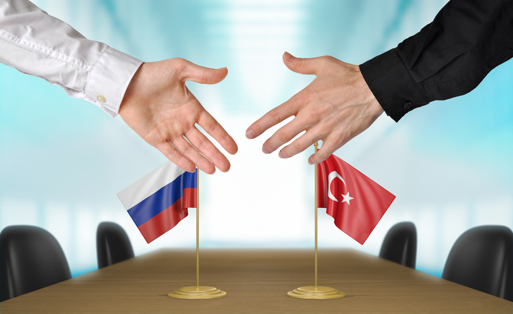 Russia and Turkey diplomats agreeing on a deal