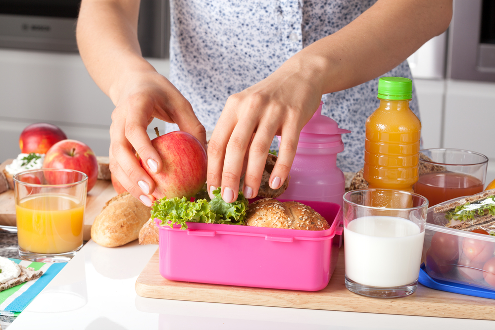 Young woman packing school lunch